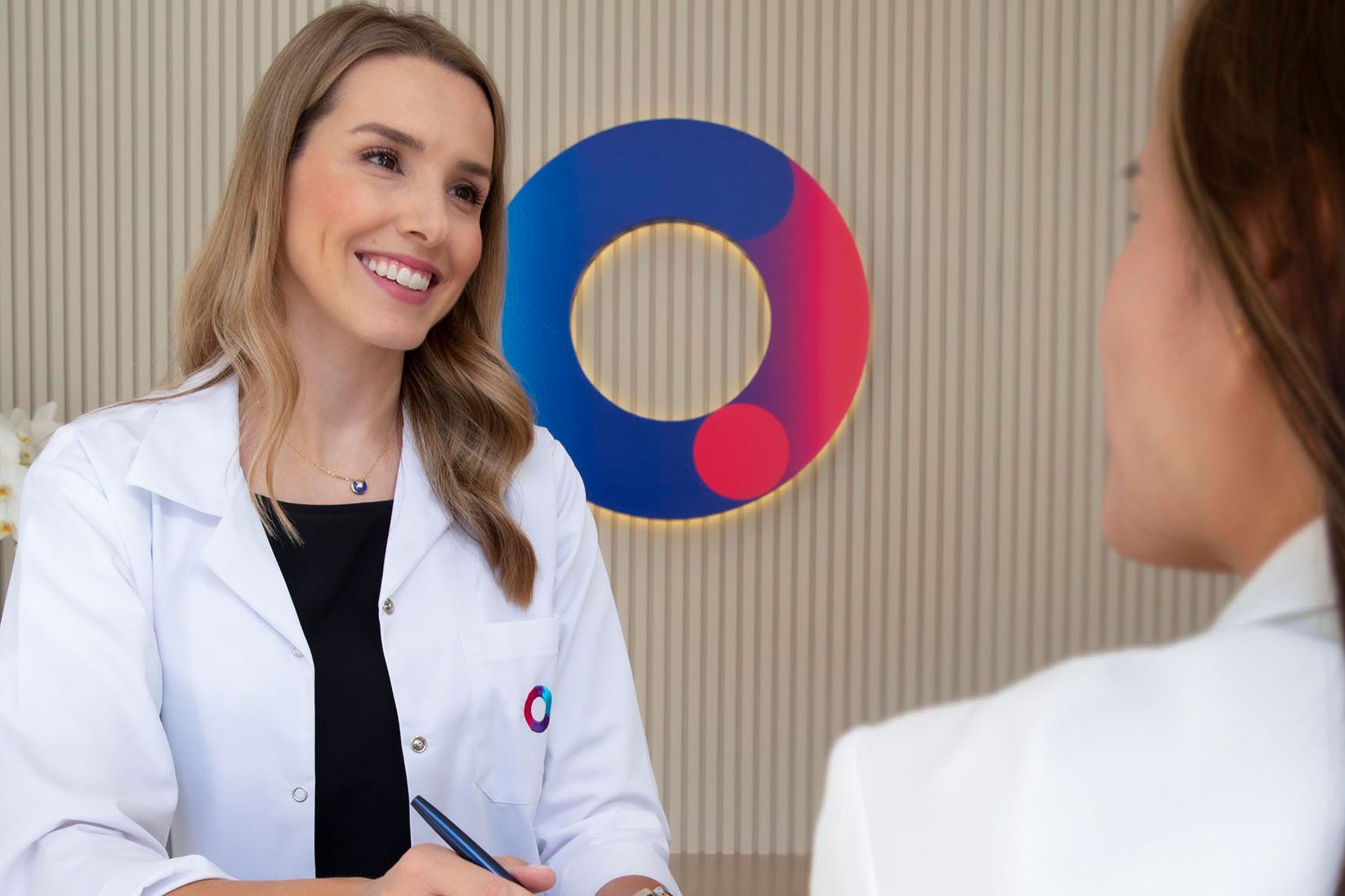 A Circle Care doctor in front of the clinic’s logo