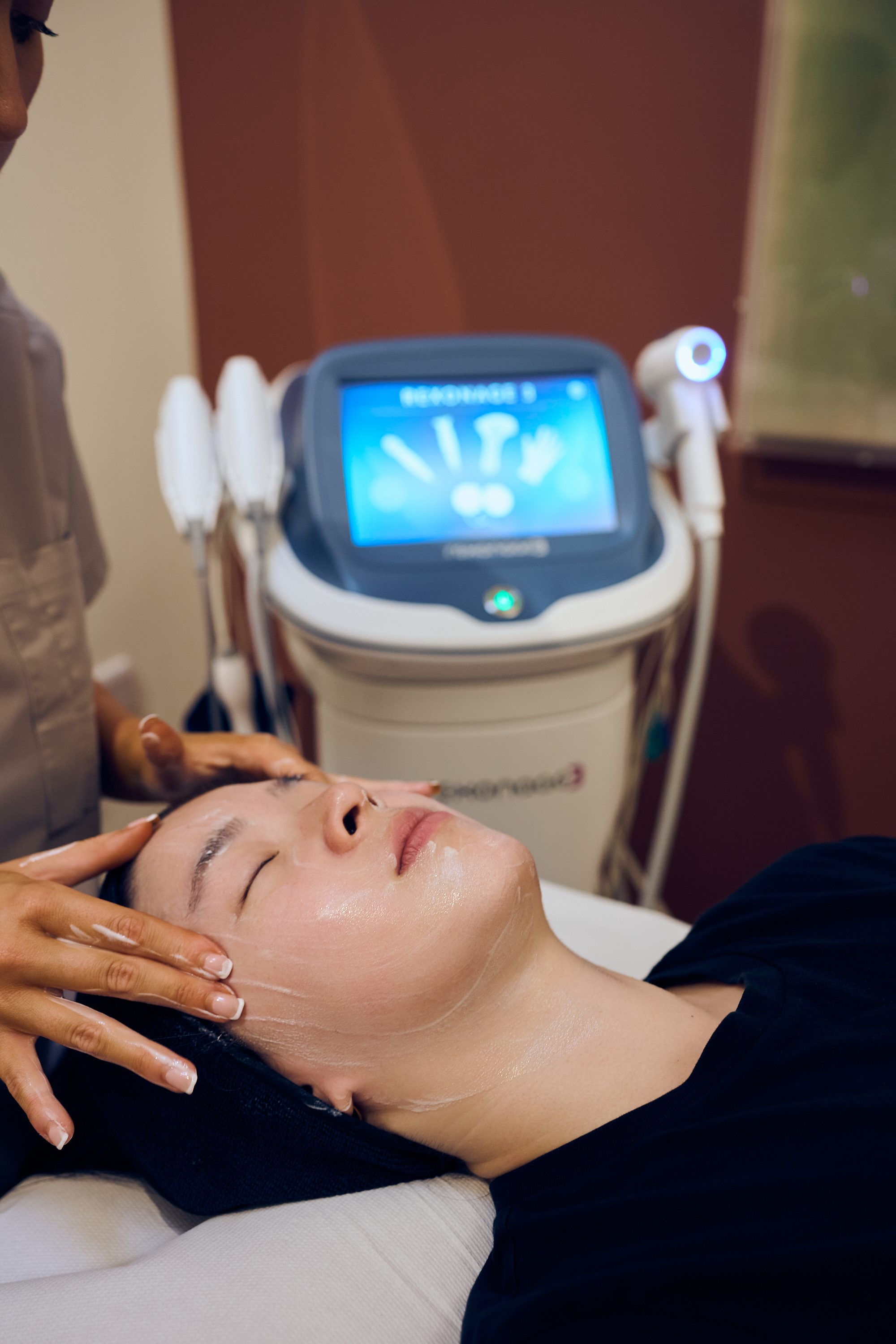 A practitioner during a facial treatment