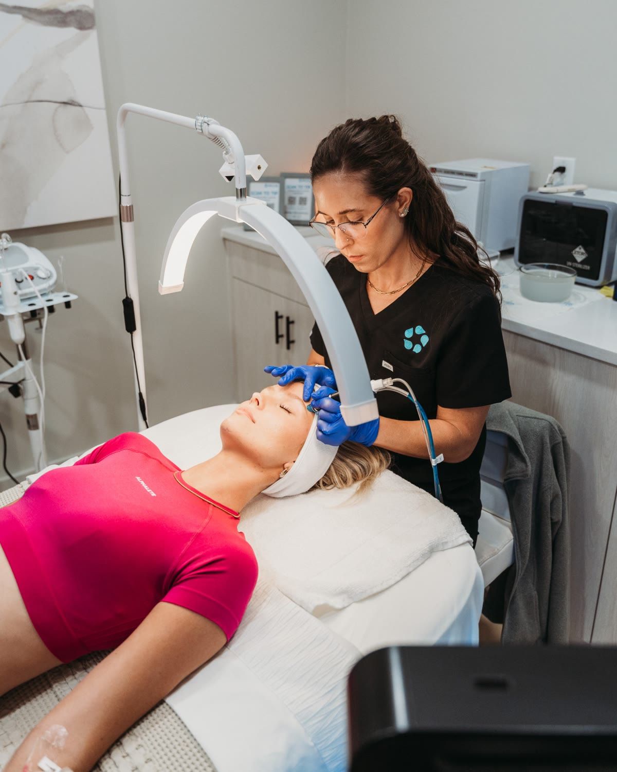 An esthetician performing a facial treatment