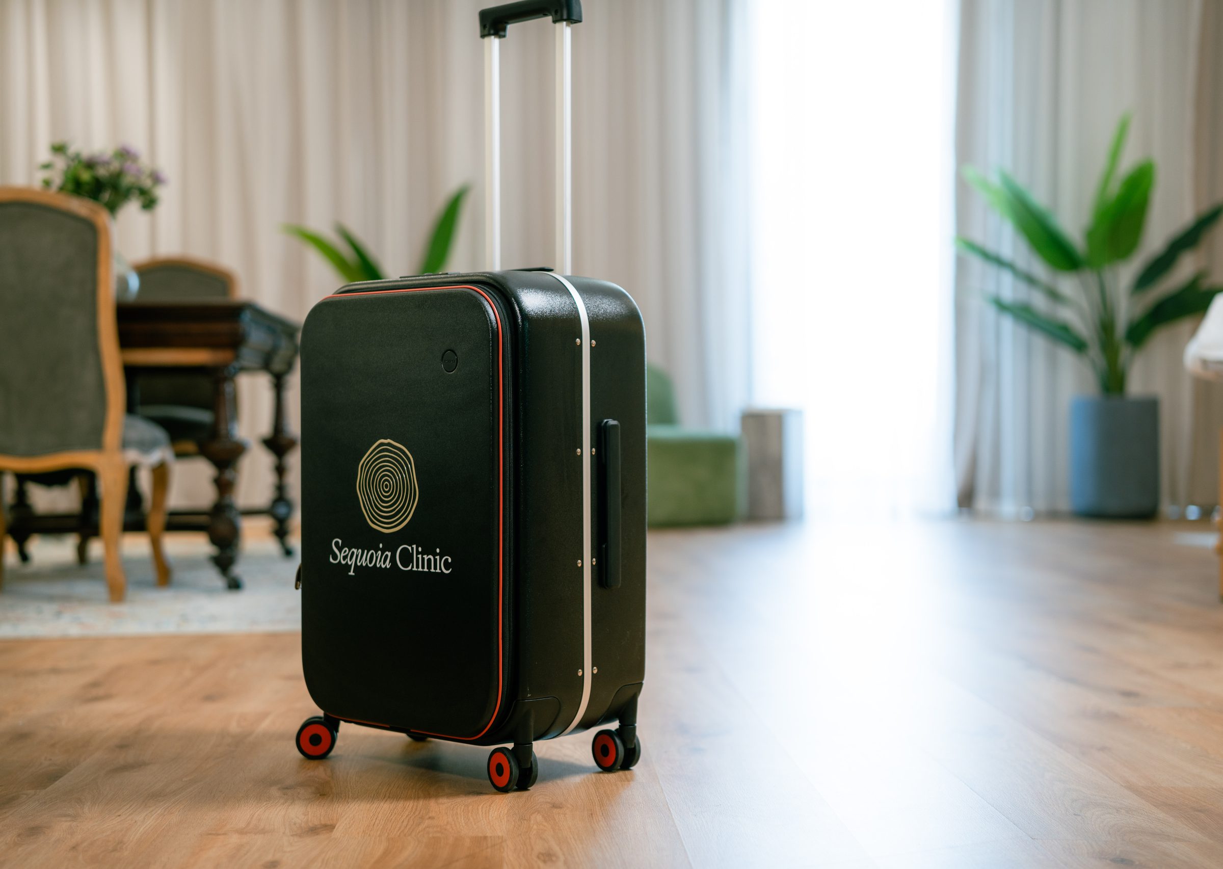 A black Sequoia Clinic case with the gold emblem, used on home visits