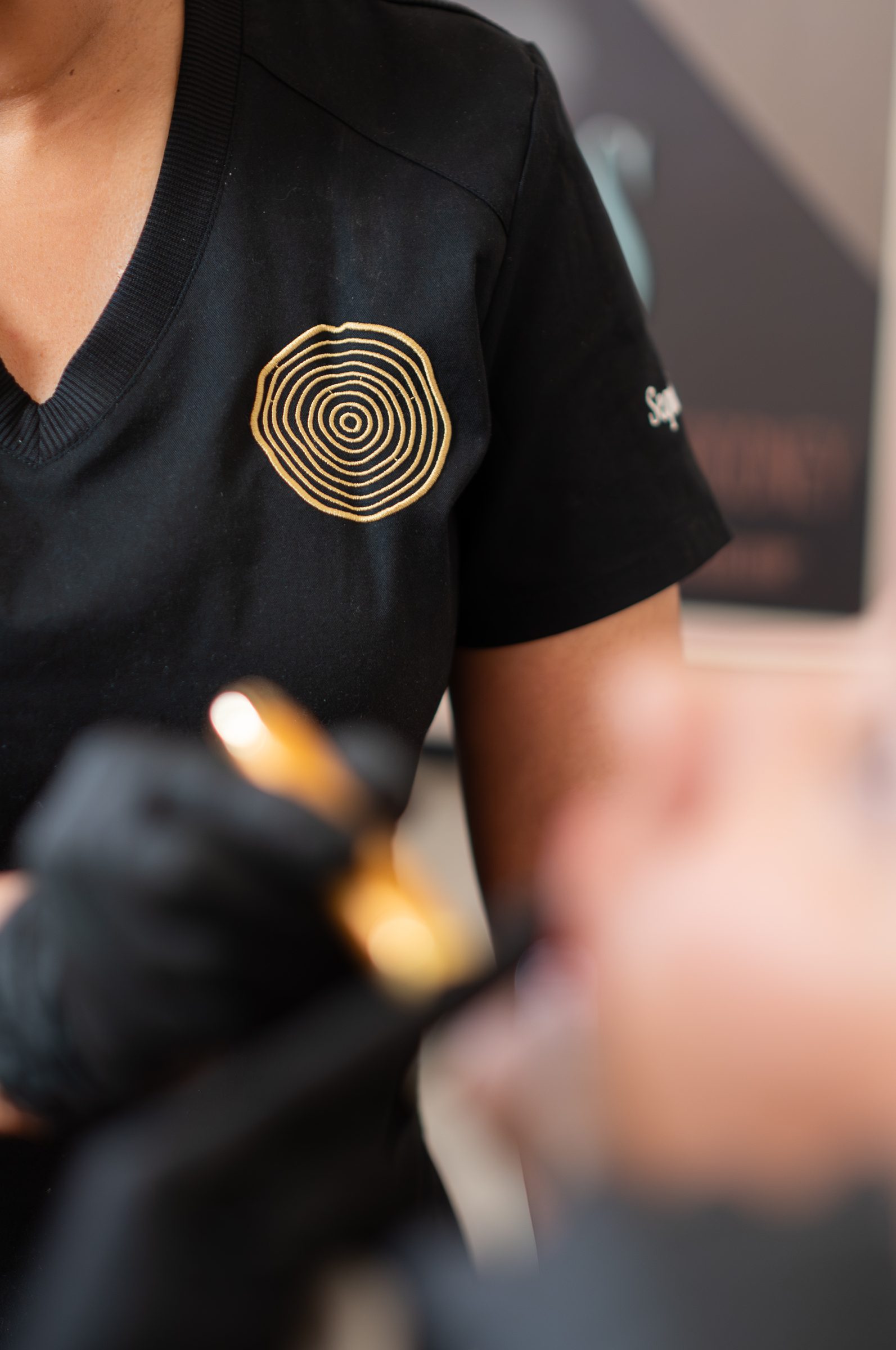The gold emblem embroidered on a practitioner’s black uniform