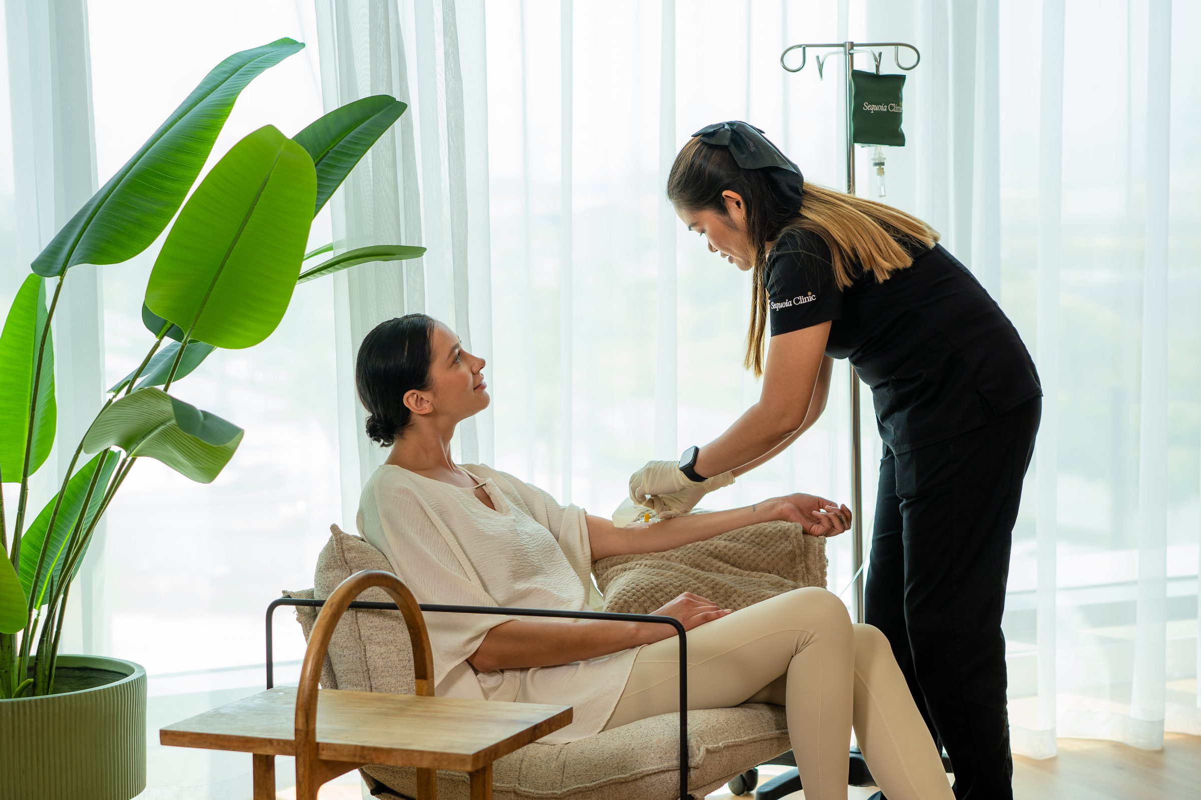 A Sequoia nurse setting up an IV drip during a home visit
