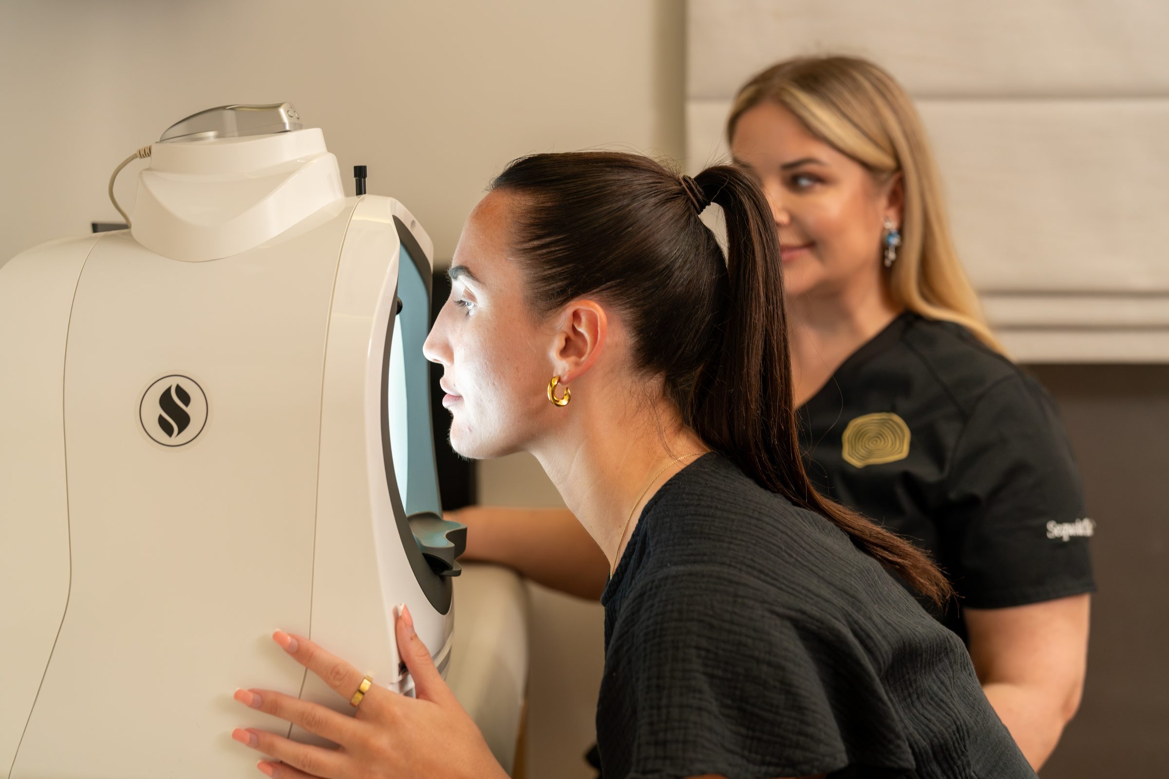 A patient using a skin analysis device with a practitioner