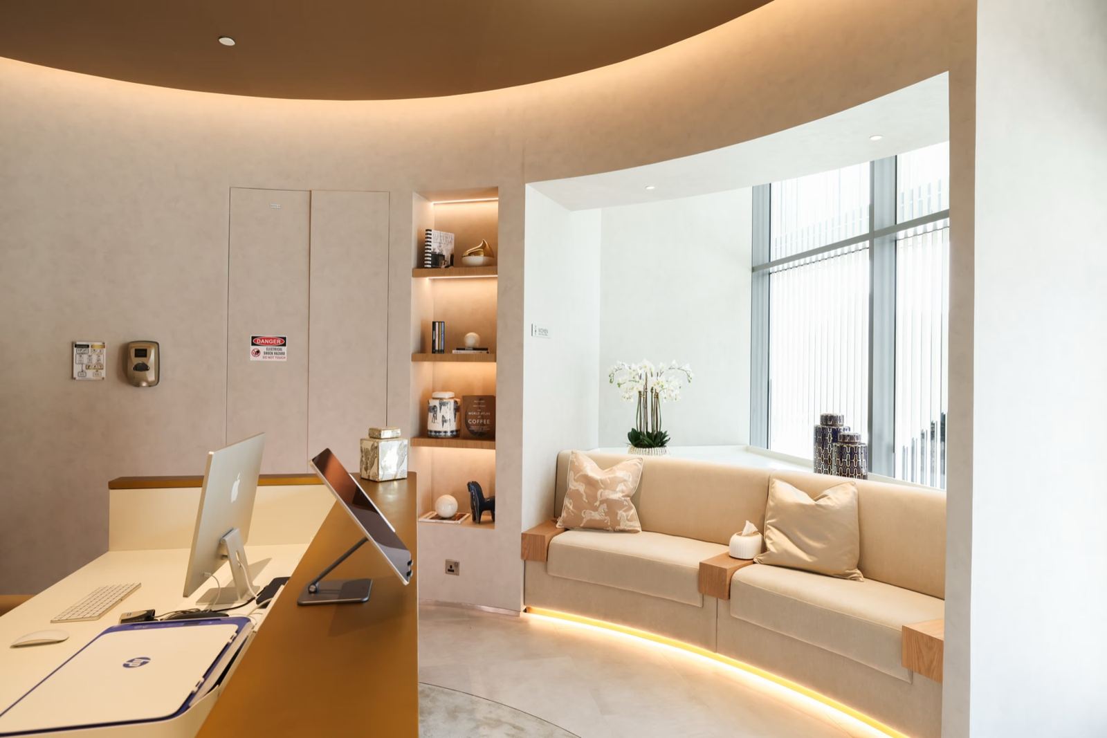 A consultation lounge with a curved sofa at Shookra Business Bay